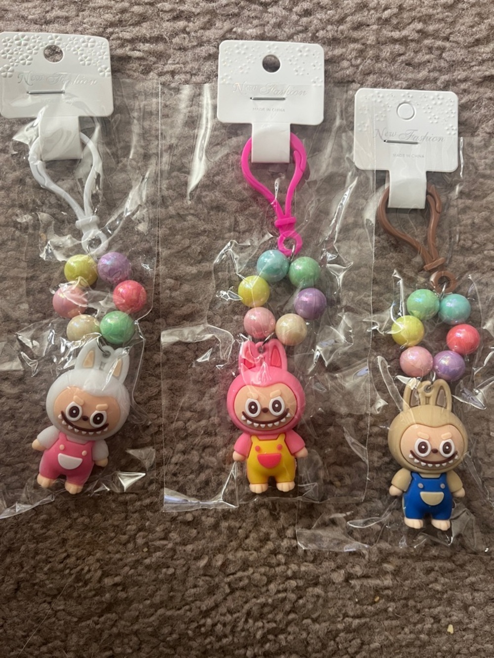 Choice of One Monster Kids Character Keychain - Pink, White, Beige